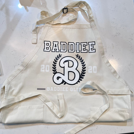 Beige Apron with black and white Baddiee logo